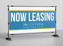 An apartment sign that says "Now Leasing".