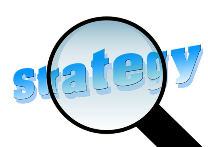 Magnifying glass. Identify strategies.