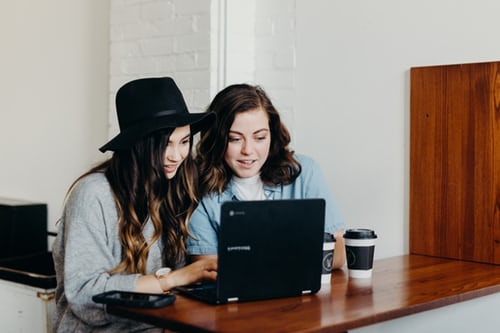 girls checking out computer