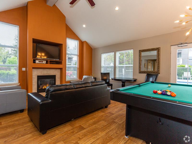 Apartments in Gresham, OR - Stark Street Crossings Club House with Billiards Table, TV, and a Fireplace