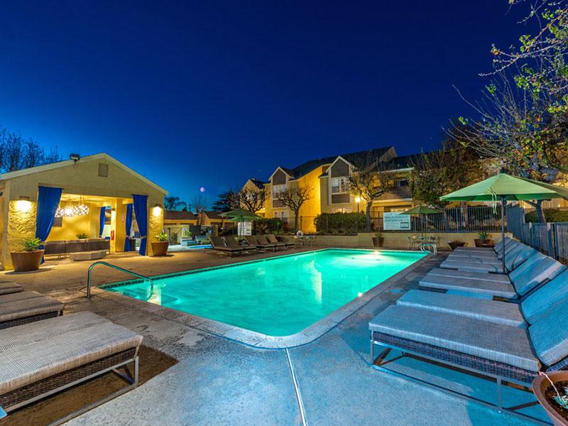 Upland Apartments-Parc Claremont Swimming Pool Surrounded by Lounge Chairs and Shaded Tables near Hot Tub
