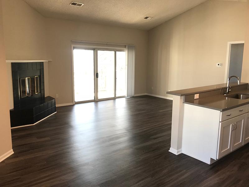 Apartments in Naperville, IL - Modern Living Room with Hardwood Flooring, a Fireplace and Access to Outdoor Patio