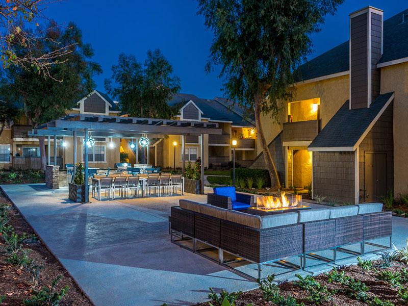 Upland CA Apartments for Rent - Parc Claremont - Outdoor BBQ Area with Two Grills, Tables, and Firepit Seating