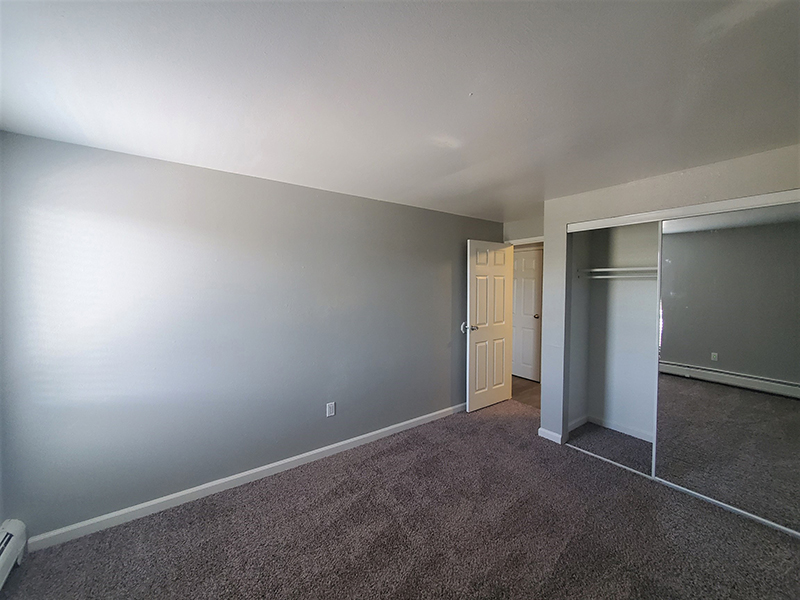 Carpeted Bedroom | Riviera Apartments in Northglenn, CO