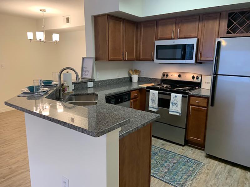 Model kitchen with a breakfast bar and stainless steel appliances in Brandon, FL.