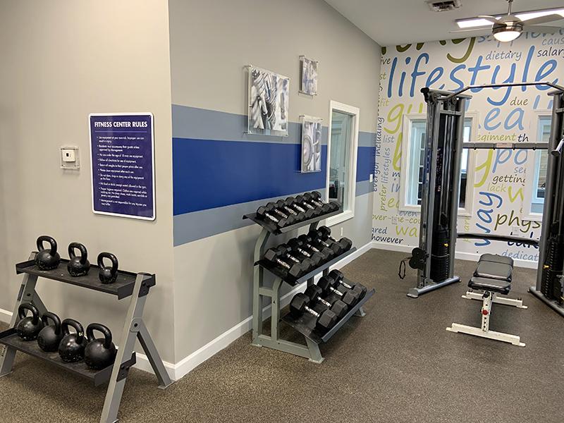 Exercise equipment in the community gym at Bridgewater at Town Center Apartments in Hampton.