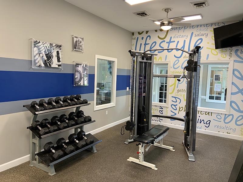 Community gym with cardio equipment and weight machines at Bridgewater at Town Center Apartments in Hampton.