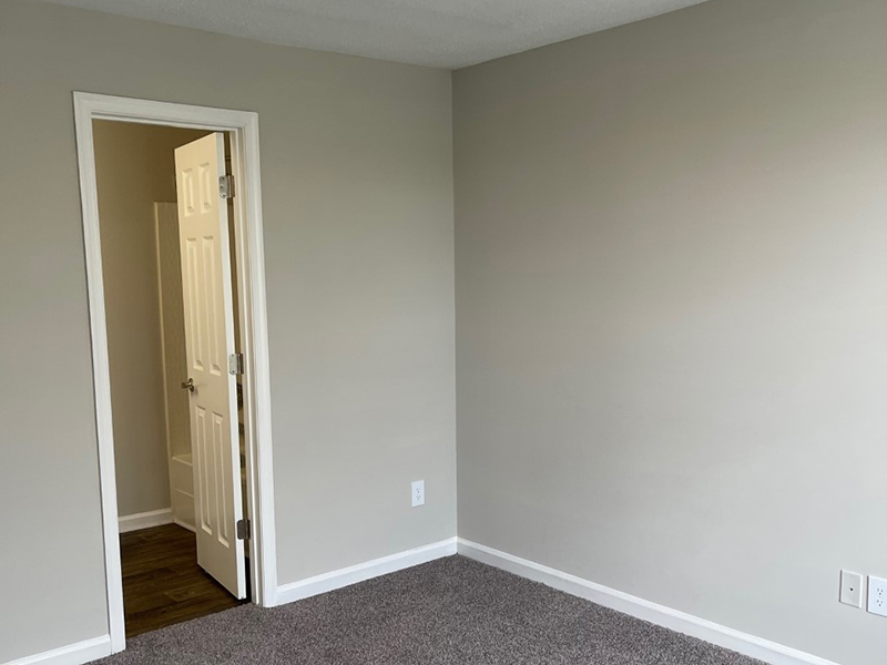 A bathroom is attached to the bedroom in an apartment in Hampton.