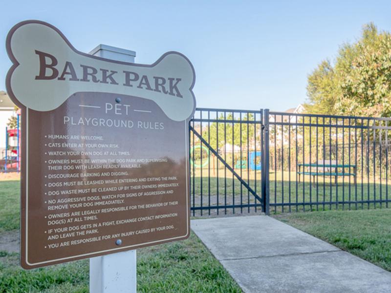 The sign to the bark park with pet playground rules at The Lakes at Town Center Apartments.