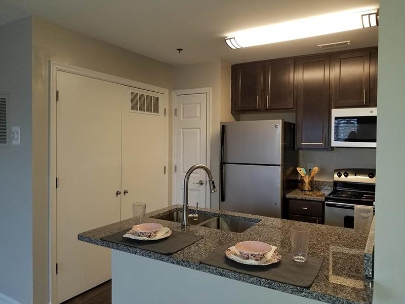 Model kitchens at Bridgewater at Town Center Apartments in Hampton have a breakfast bar and stainless steel appliances.