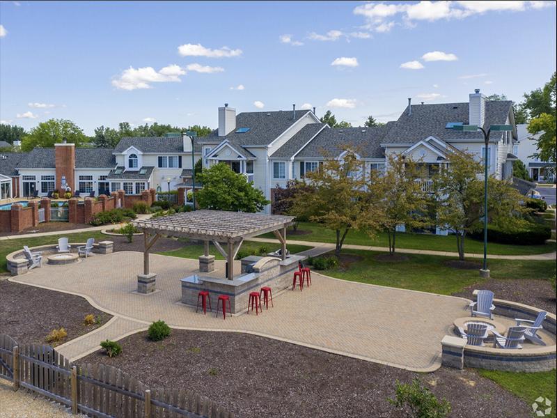 Naperville, IL Apartments - Exterior View of Arbors of Brookdale Apartments Building Surrounded By Lush Landscaping and Outdoor Grilling Area