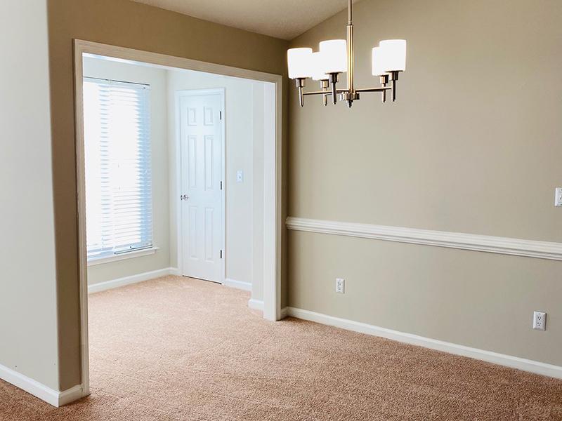 A chandelier hangs above a carpeted room in the apartments at The Lakes at Town Center in Hampton.