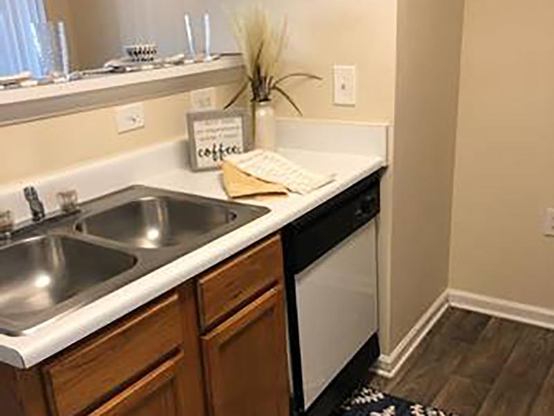 The apartments at Bridgewater at Town Center in Hampton have kitchens with modern appliances and wood-style flooring.