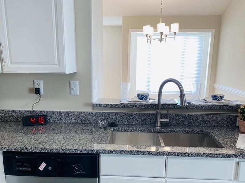 A double sink and granite-style countertops in the kitchens at The Lakes at Town Center Apartments.